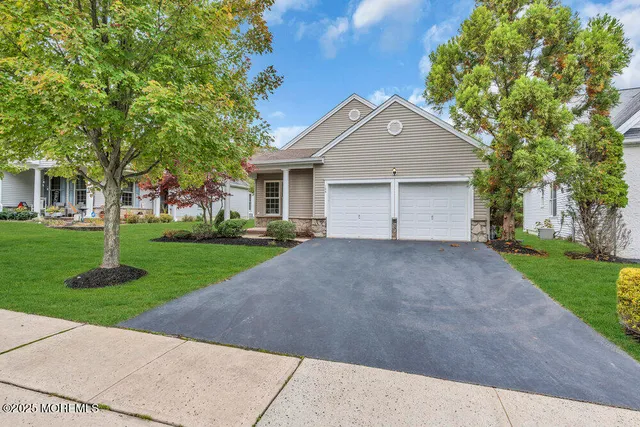 a front view of house with yard and green space