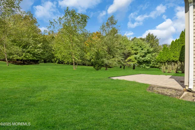 a living room with lots of furniture and a large window