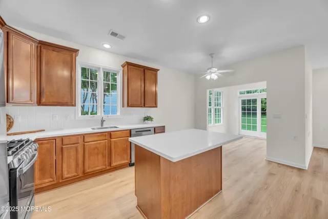 a kitchen with a refrigerator sink and stove