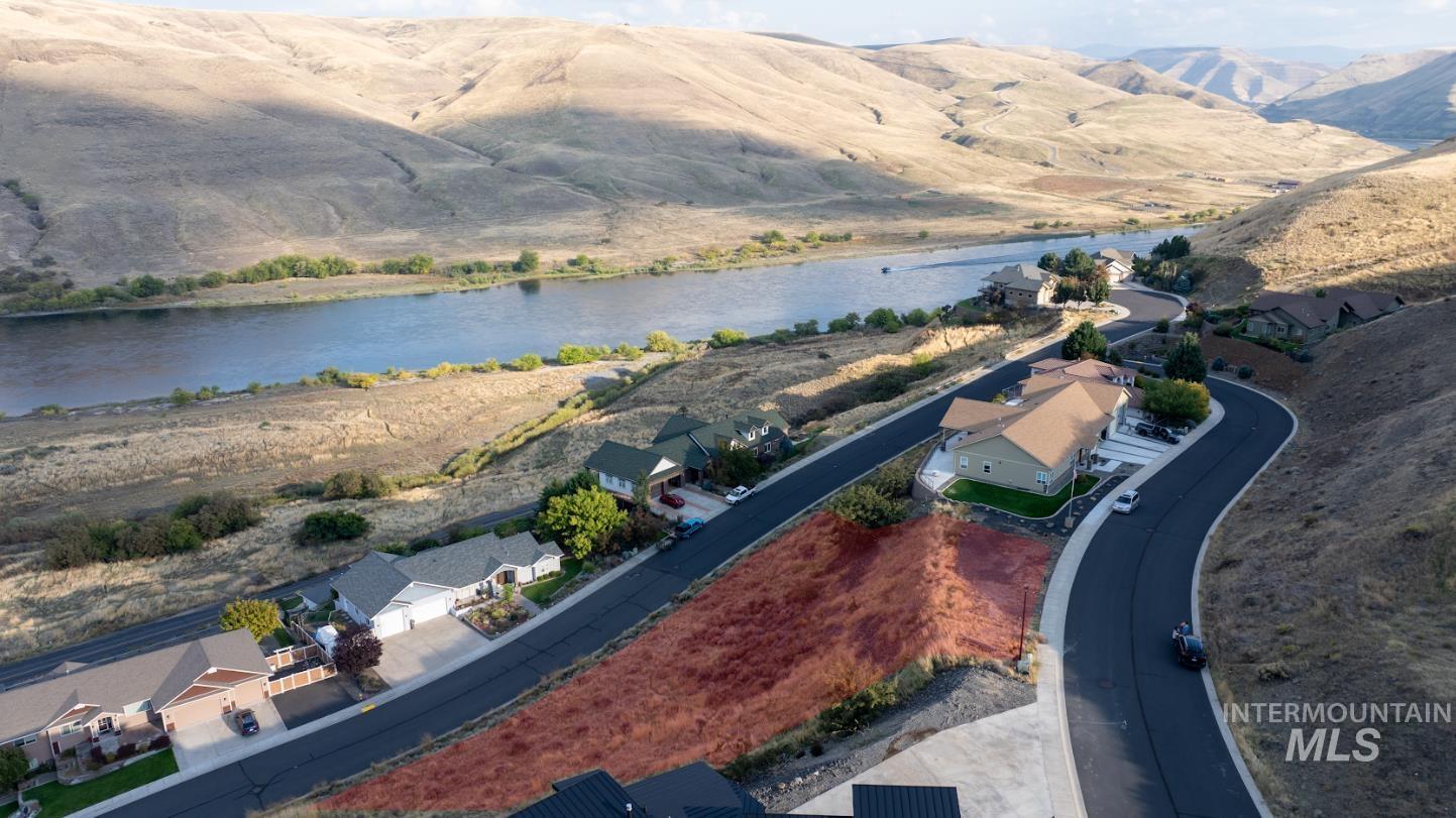 Aerial view of residential area featuring a water and mountain view