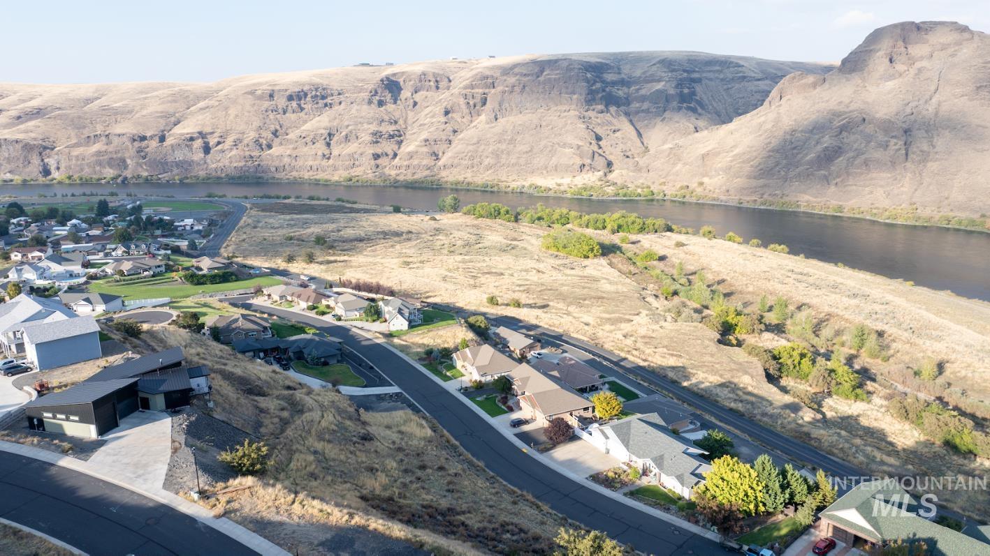 1493 River Ridge Drive Asotin, WA 99402 - Photo 11 of 14 Aerial view of property and surrounding area with nearby suburban area and a nearby body of water