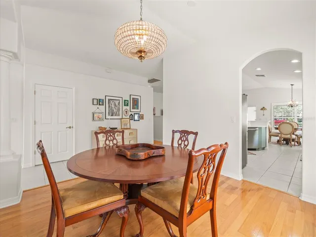 a view of a dining room with furniture and chandelier