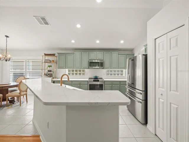 a kitchen with stainless steel appliances granite countertop a sink and cabinets