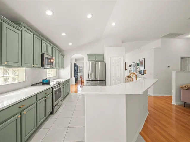 a kitchen with stainless steel appliances granite countertop a sink and a microwave