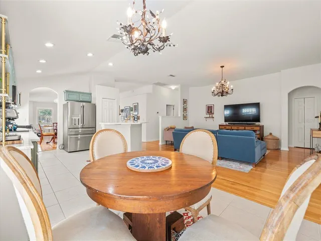 a living room with furniture and a dining table