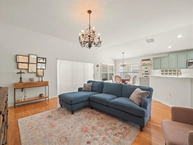 a living room with furniture and a chandelier