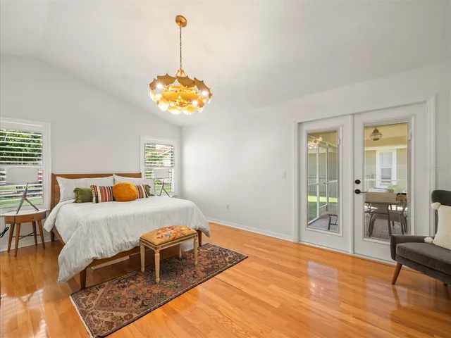a bedroom with a bed and a chandelier