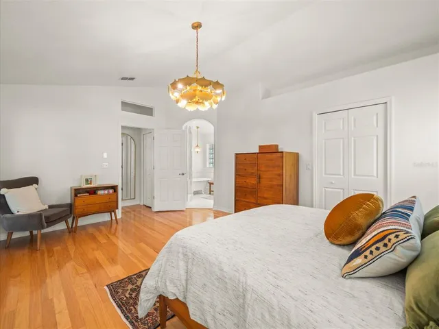 a bed sitting in a bedroom next to a window