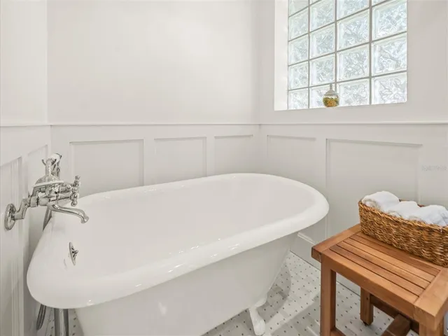 a bedroom with a bed and a chair