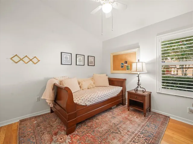 a bathroom with a bathtub shower sink vanity mirror and toilet