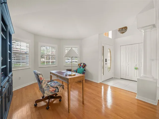 a workspace with furniture hardwood and a window
