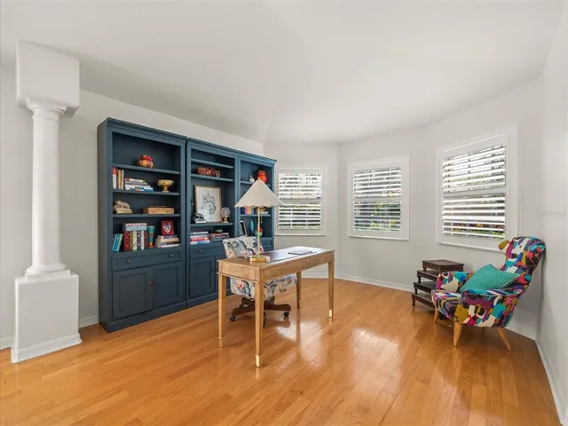 a workspace with furniture window and wooden floor