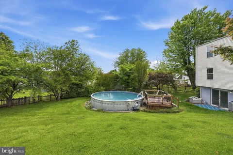 a view of a house with backyard sitting area and garden