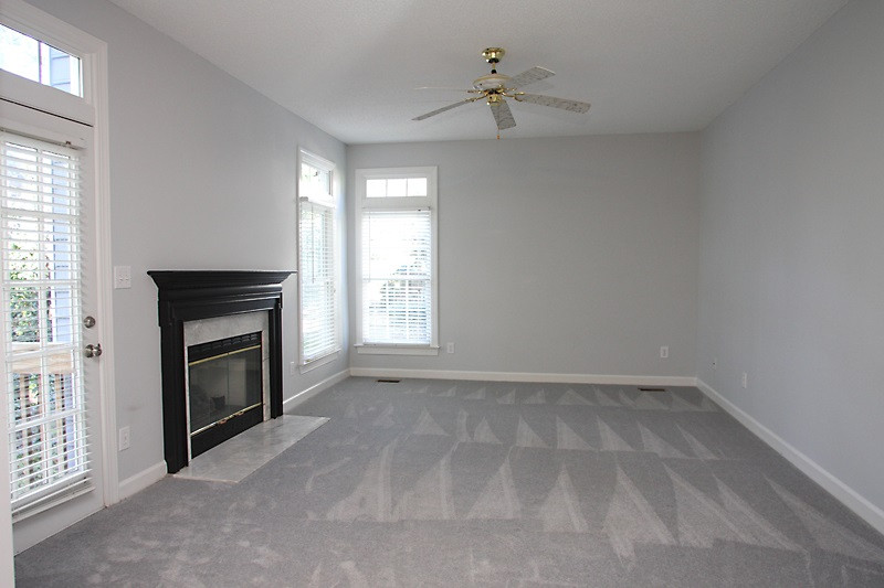 9021 Breeland Way Raleigh, NC 27613 - Photo 10 of 20 Great family room that is continuation of kitchen! Corner windows, natural gas fireplace, French door to deck and private backyard! Fabulous family room !