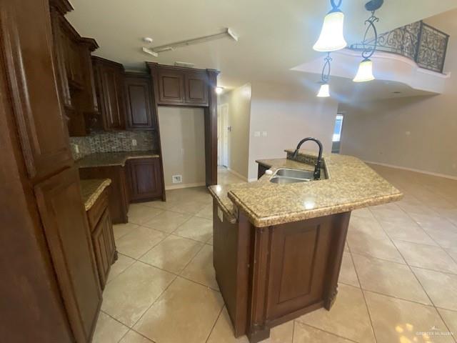 609 River Point Street Rio Grande City, TX 78582 - Photo 5 of 22 a kitchen with stainless steel appliances granite countertop a sink a refrigerator and a wooden cabinets
