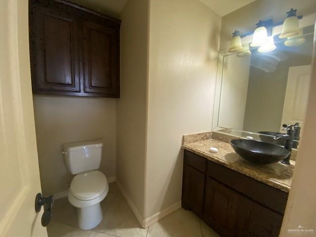 609 River Point Street Rio Grande City, TX 78582 - Photo 9 of 22 a bathroom with a granite countertop sink and a toilet