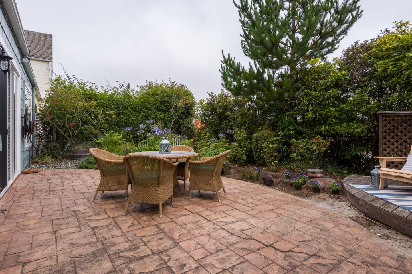 29 Pinehurst Lane Half Moon Bay, CA 94019 - Photo 15 of 17 a wooden bench sitting in backside of a house with yard and seating area