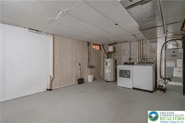 a view of a storage & utility room with a fridge