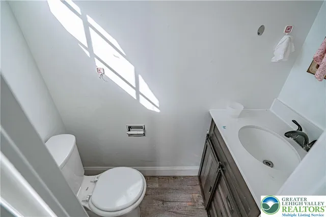 a white toilet sitting next to a bathroom sink and tub