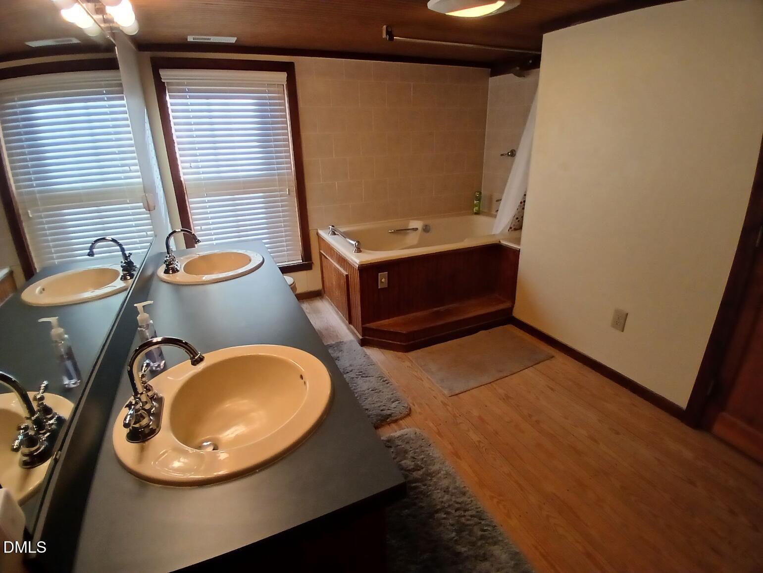1920 Kelly Road Apex, NC 27502 - Photo 38 of 44 a bathroom with a sink mirror vanity and toilet