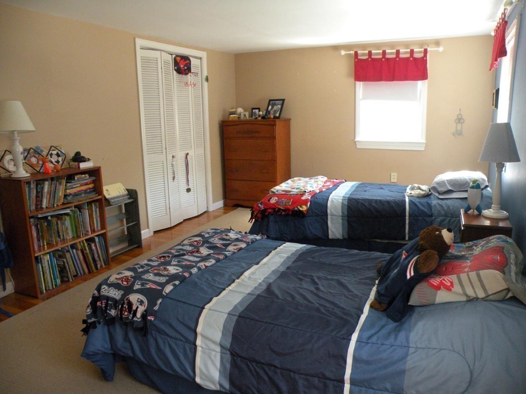 6 Kingsbury Road Canton, MA 02021 - Photo 18 of 26 a bedroom with a bed and a book shelf