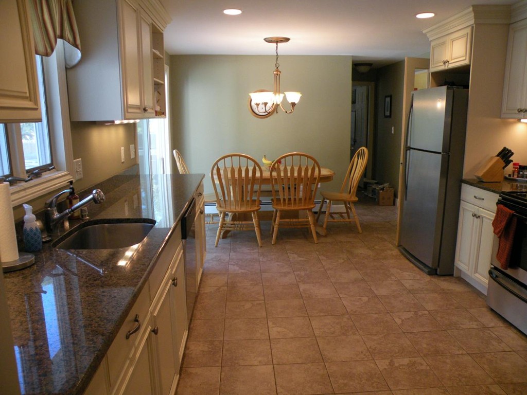 6 Kingsbury Road Canton, MA 02021 - Photo 4 of 26 a kitchen with granite countertop a refrigerator a stove a sink a dining table and chairs