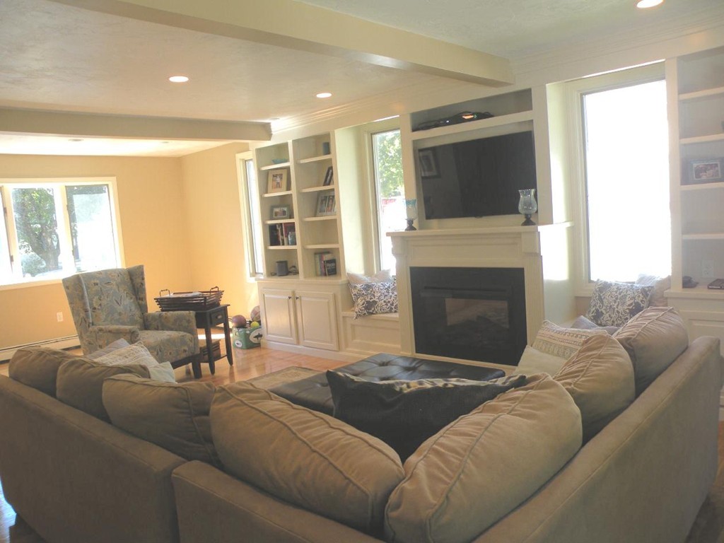 6 Kingsbury Road Canton, MA 02021 - Photo 7 of 26 a living room with furniture a flat screen tv and a fireplace