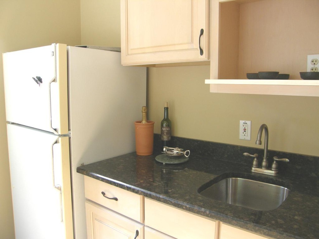 6 Kingsbury Road Canton, MA 02021 - Photo 8 of 26 a kitchen with granite countertop a sink and a refrigerator