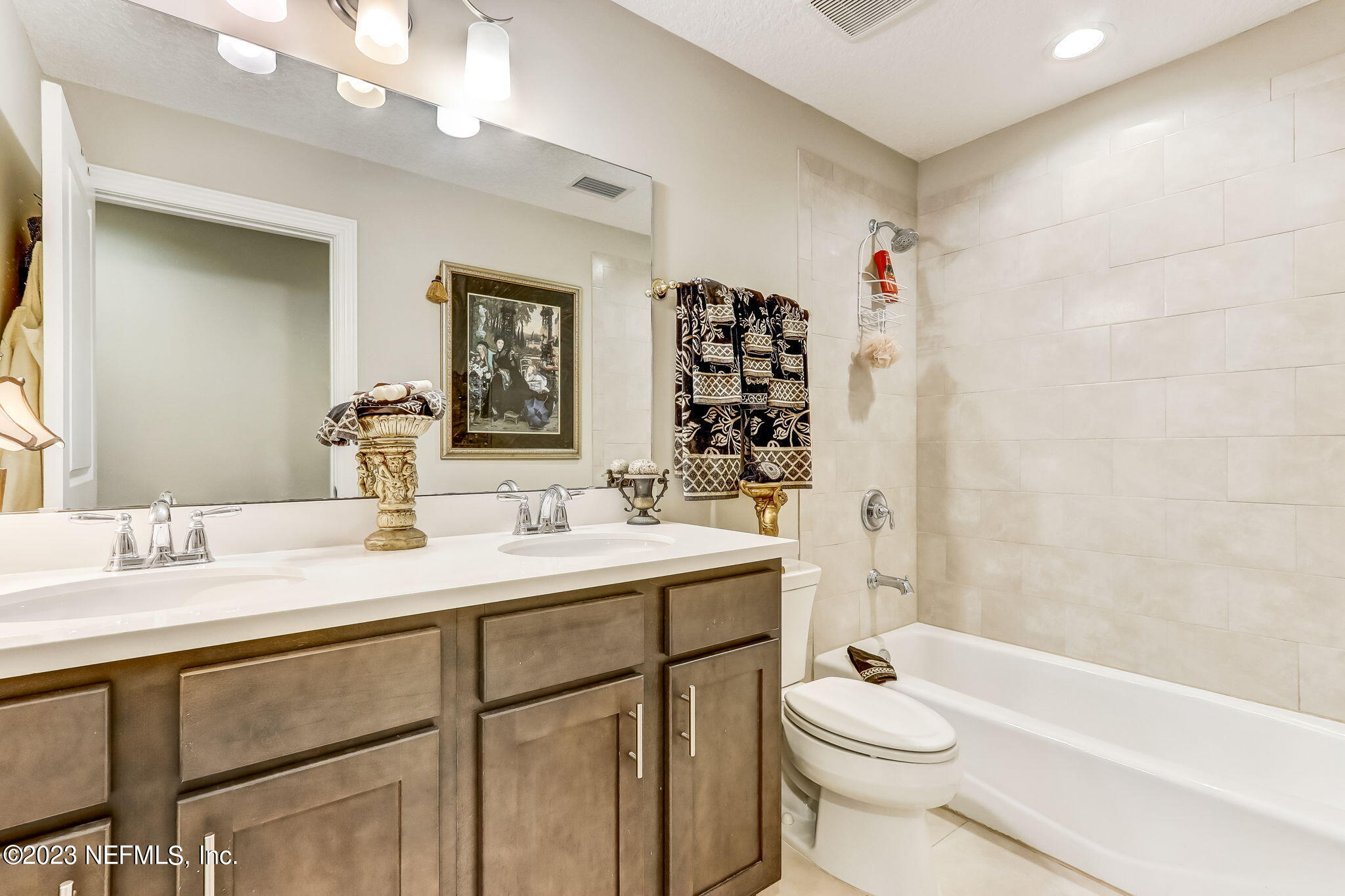 28951 Grandview Manor Yulee, FL 32097 - Photo 20 of 35 a bathroom with a sink a toilet tub and shower