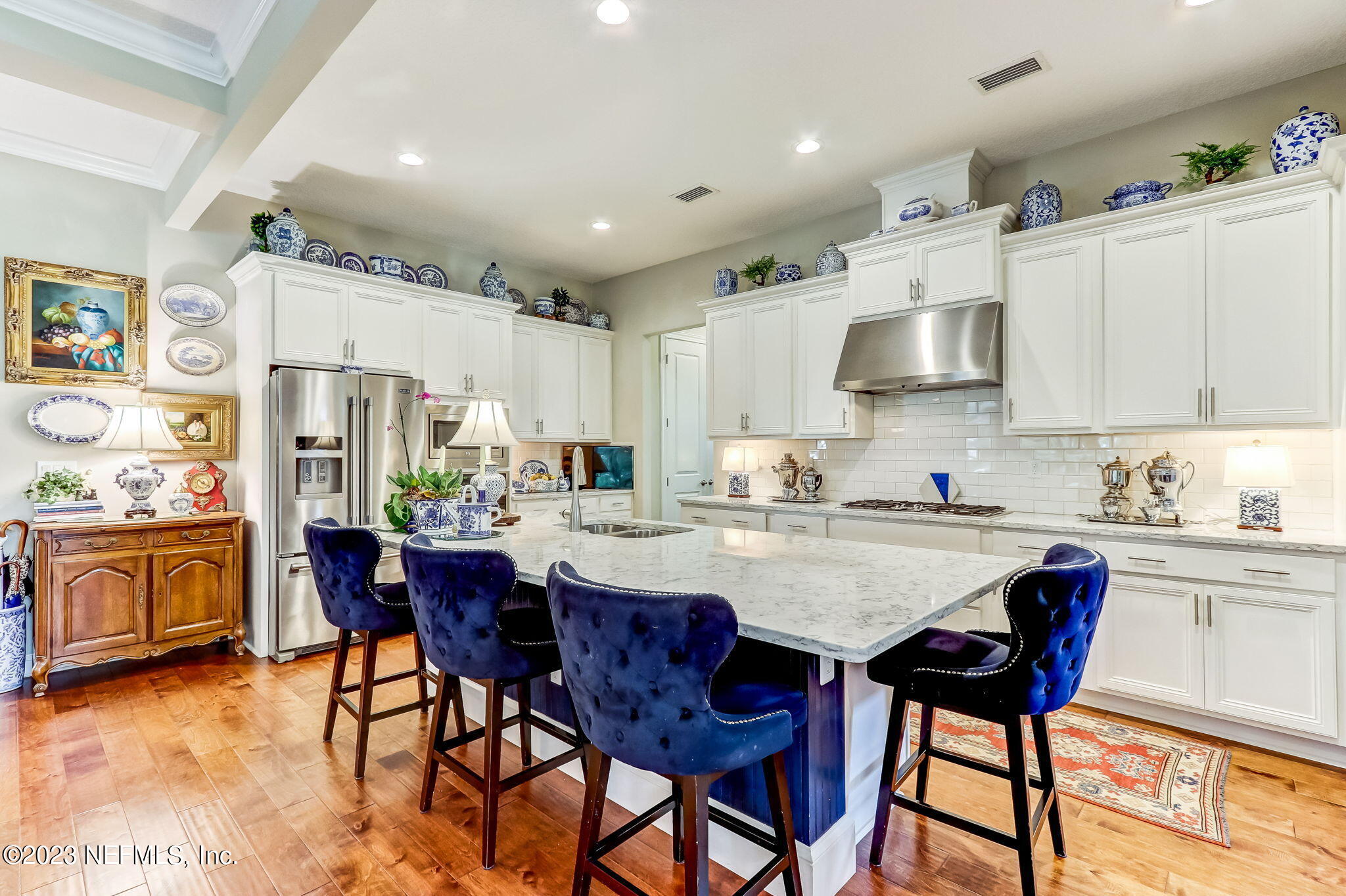 28951 Grandview Manor Yulee, FL 32097 - Photo 8 of 35 a kitchen with stainless steel appliances kitchen island granite countertop a table chairs and a refrigerator