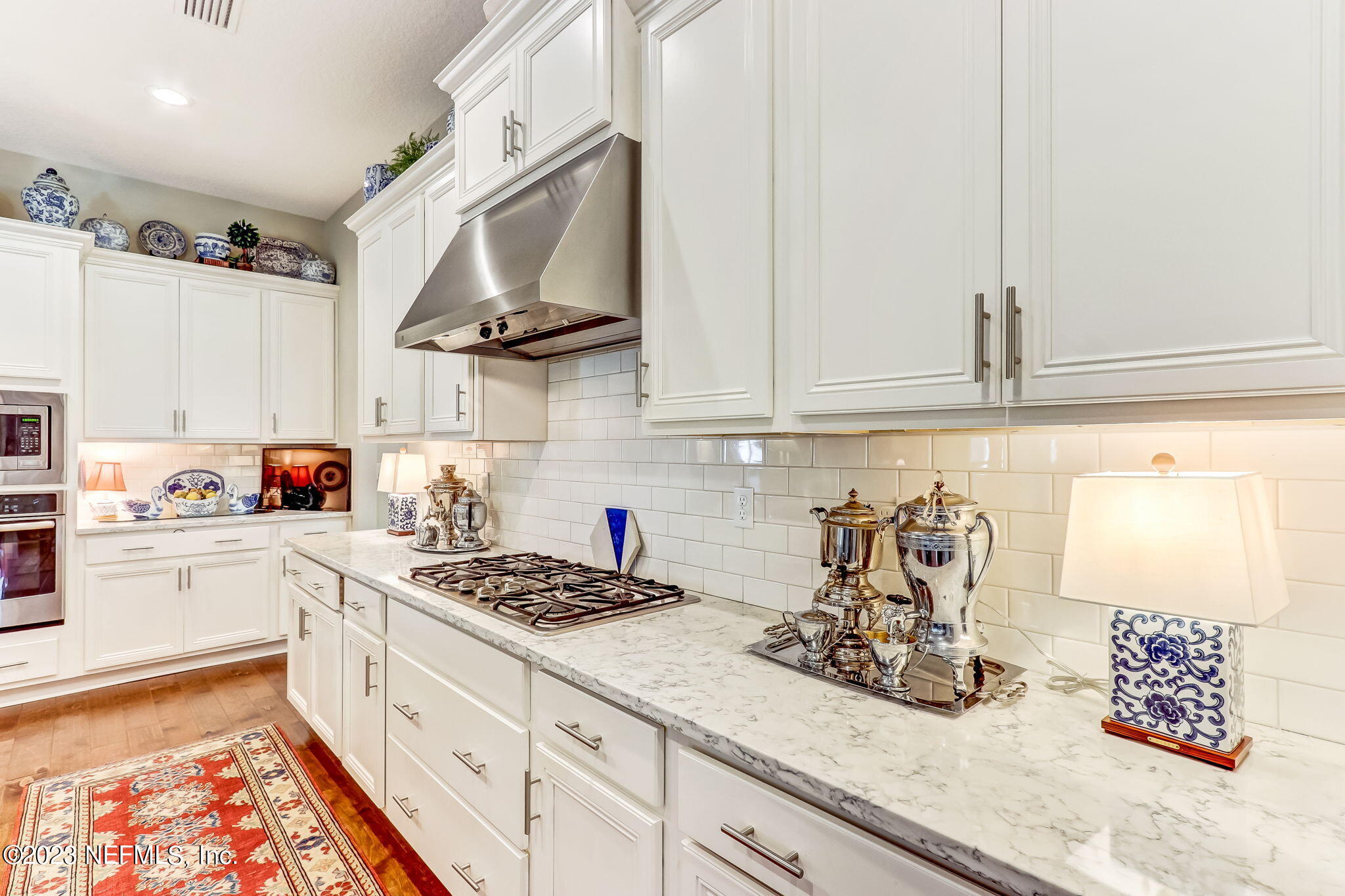 28951 Grandview Manor Yulee, FL 32097 - Photo 10 of 35 a kitchen with stainless steel appliances granite countertop a sink stove and white cabinets