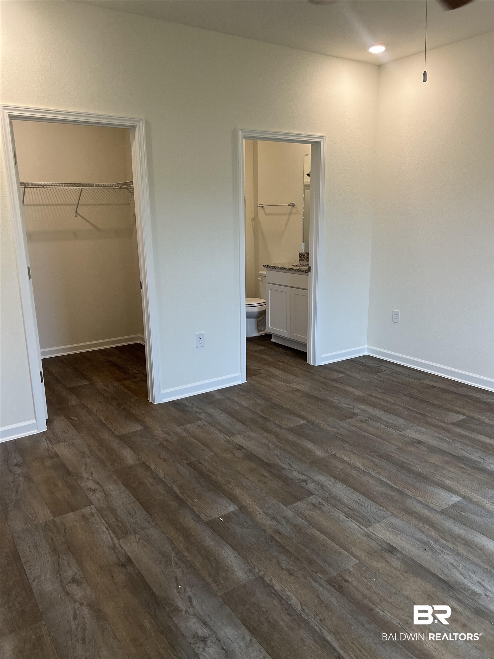 12829 Patriot Way Daphne, AL 36527 - Photo 24 of 38 Unfurnished bedroom featuring a closet, a spacious closet, dark wood-type flooring, and connected bathroom