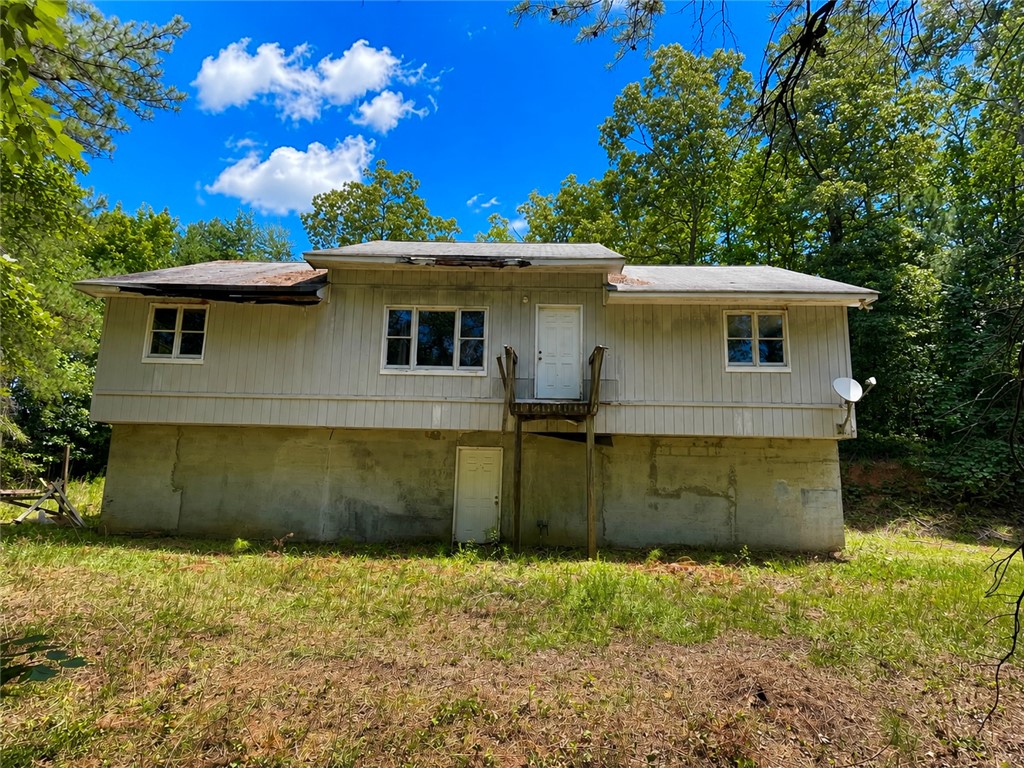 A secluded dwelling nestled amidst abundant trees offers a tranquil retreat.