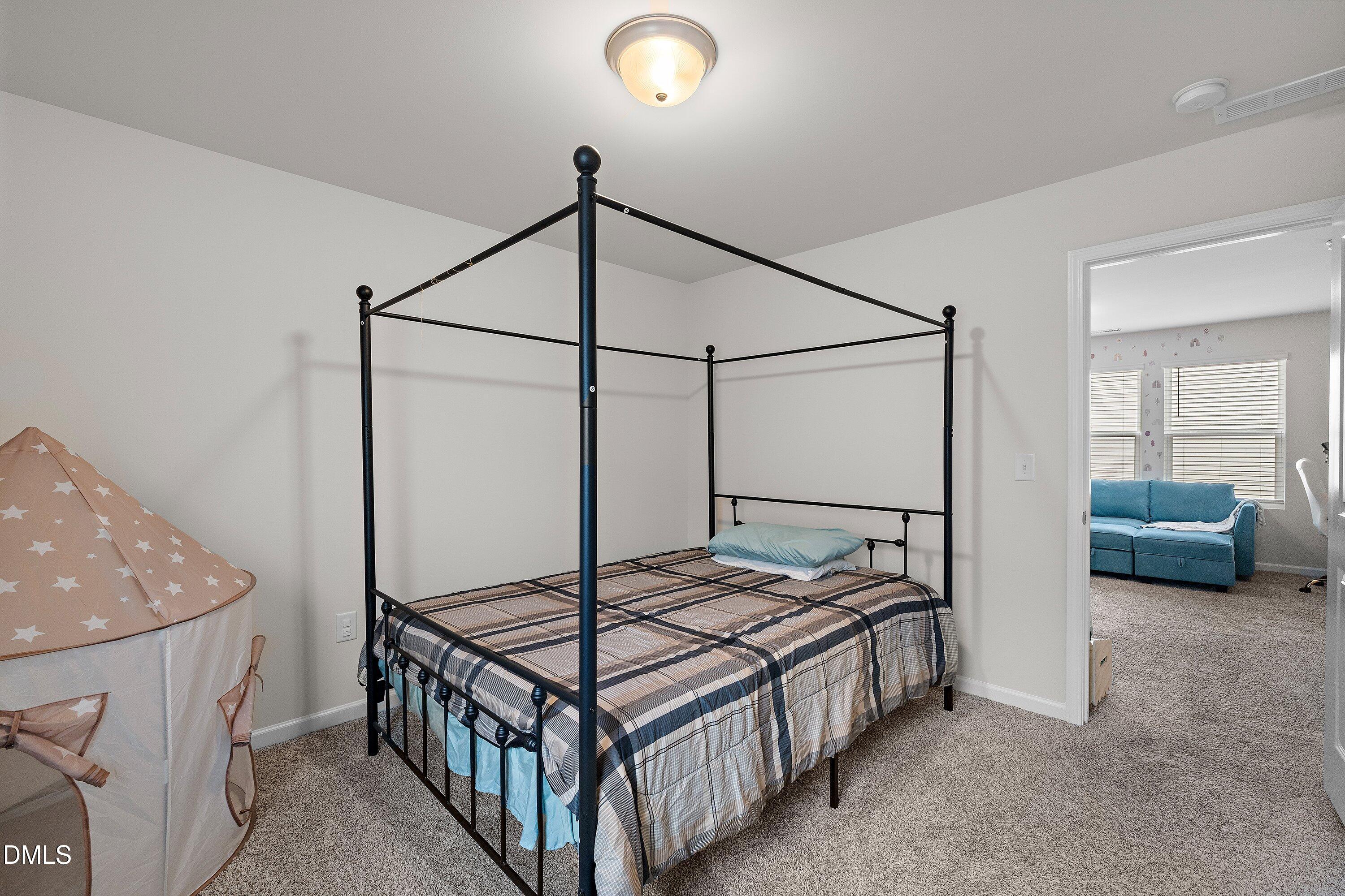 154 Anise Tree Way Clayton, NC 27527 - Photo 34 of 43 a bedroom with a bed and a walk in closet