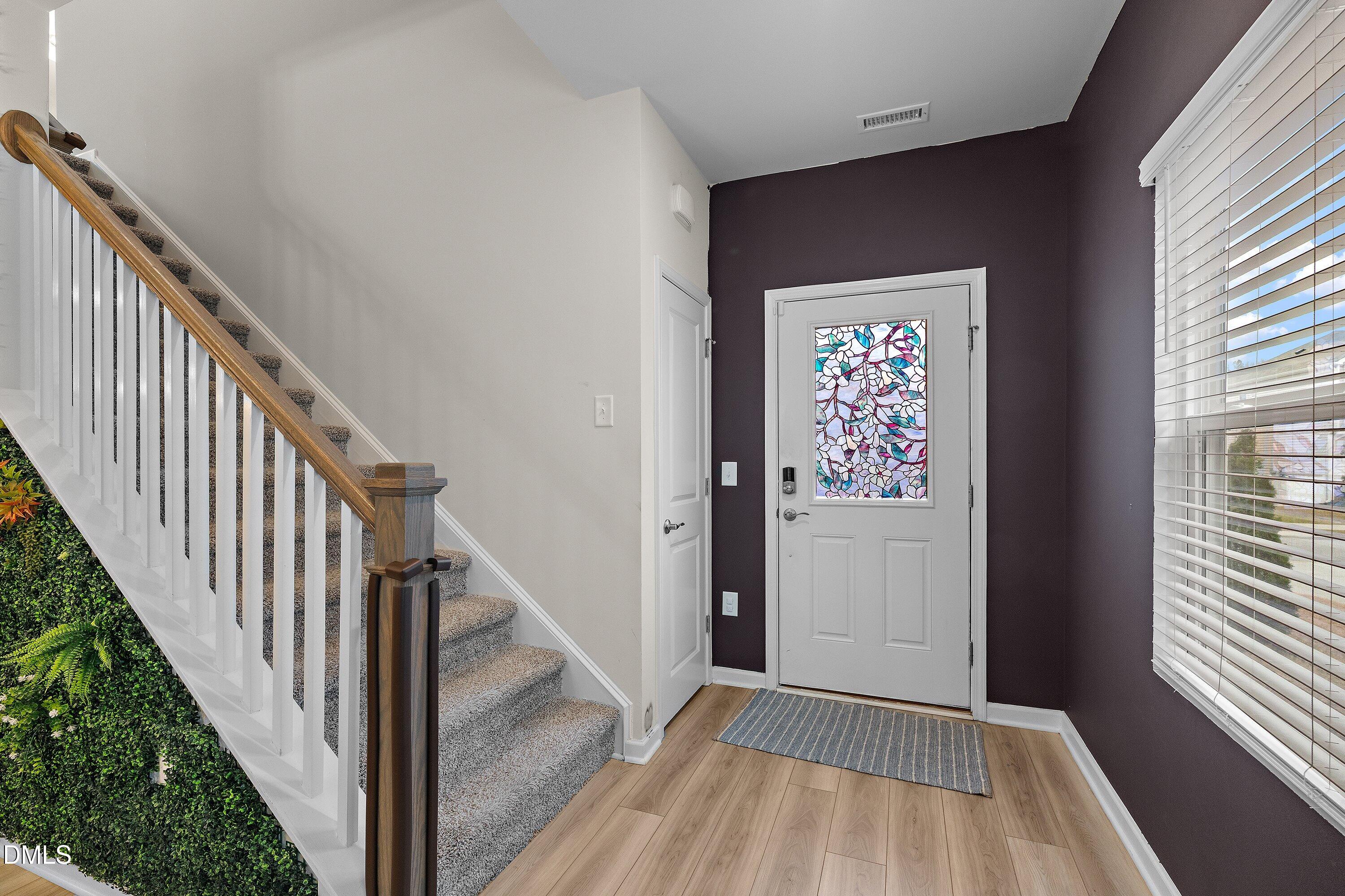 154 Anise Tree Way Clayton, NC 27527 - Photo 5 of 43 a view of a hallway with wooden floor and entryway