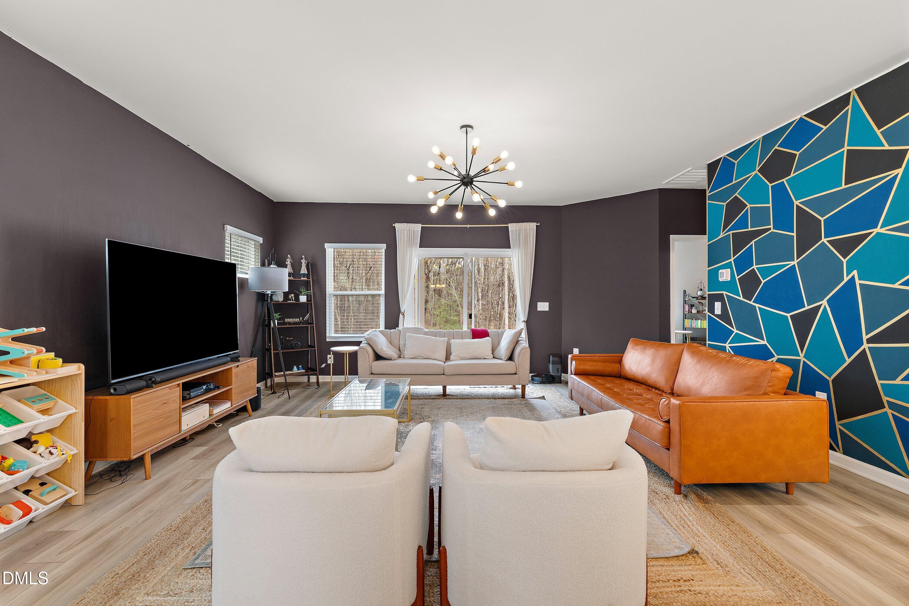 154 Anise Tree Way Clayton, NC 27527 - Photo 10 of 43 a living room with furniture and a flat screen tv