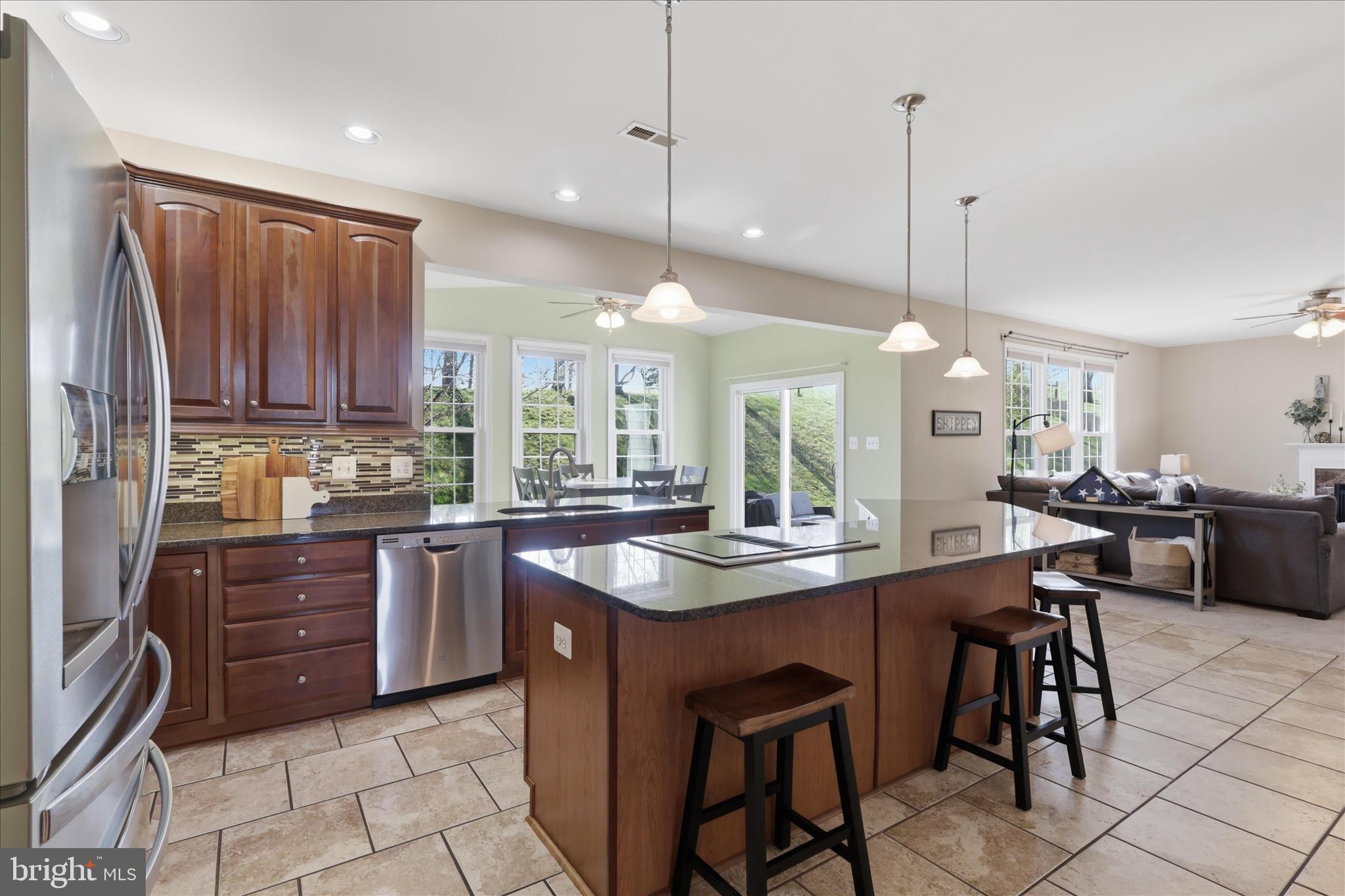305 Tiger Way Boonsboro, MD 21713 - Photo 2 of 79 a kitchen with stainless steel appliances granite countertop a stove a sink a dining table and chairs