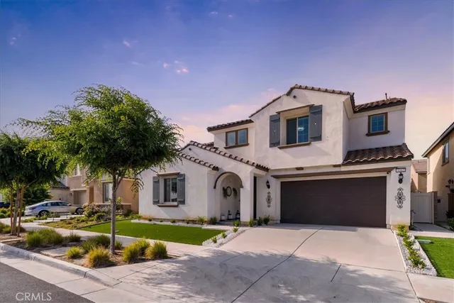 a front view of a house with a garden