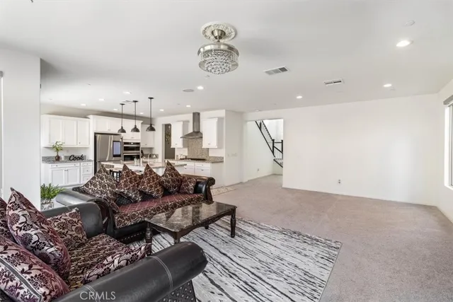 a kitchen with stainless steel appliances granite countertop a sink and a stove
