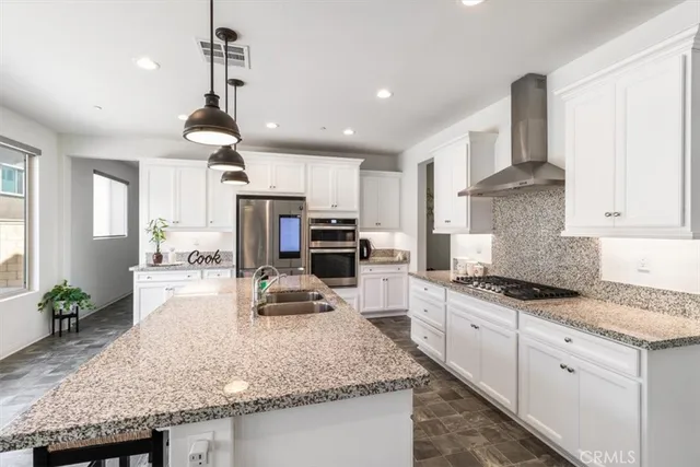 a kitchen with granite countertop a stove and a sink