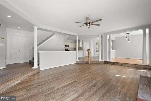 a kitchen with stainless steel appliances granite countertop a stove top oven a sink and a refrigerator