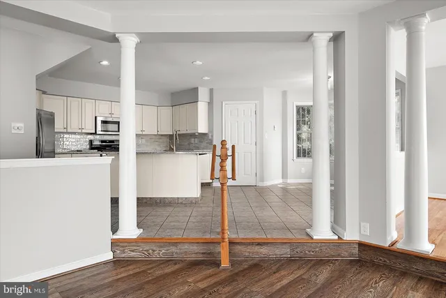 a view of a room with wooden floor and windows
