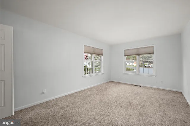a white bath tub sitting in a bathroom next to a window
