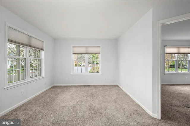 a white bath tub sitting in a bathroom next to a window