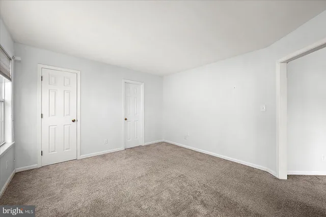 a view of an entryway with wooden floor and door