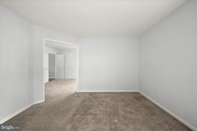 a view of a house with a backyard and a tree