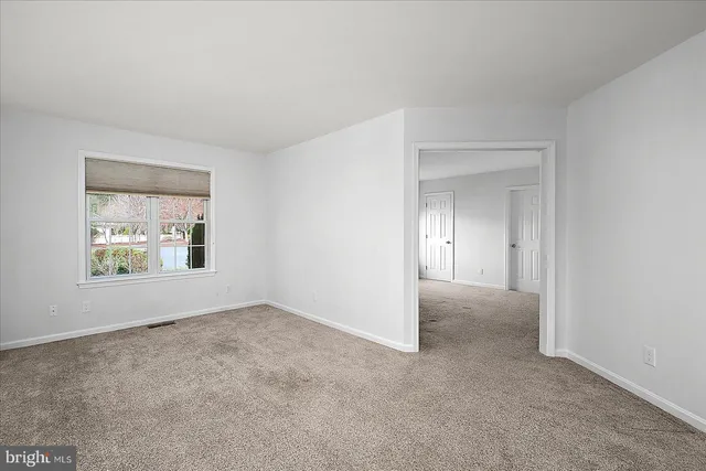 a front view of a house with a yard and trees