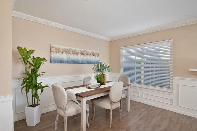 a dining room with furniture and window