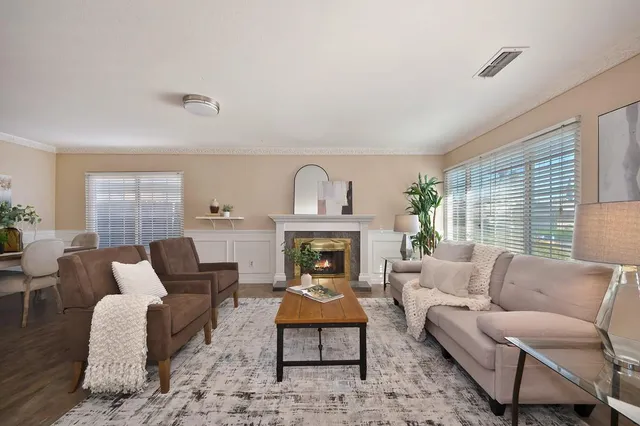 a living room with furniture fireplace and window