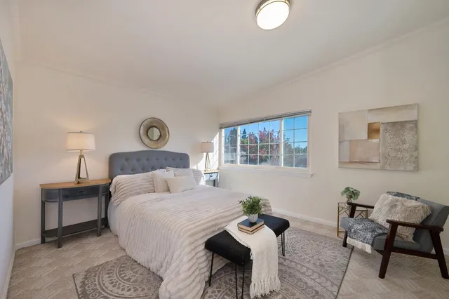 a bedroom with a bed and chair